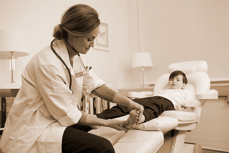 Doctor examine boys foot